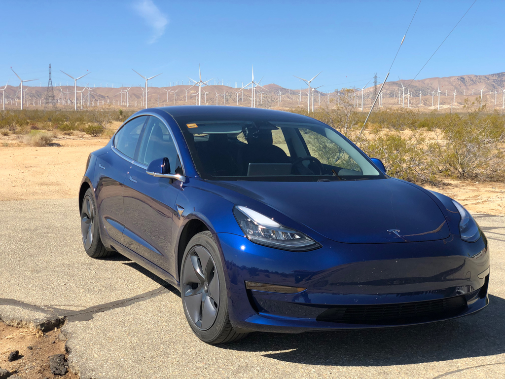 Picture of my car next to the Tehachapi Pass Wind Farm.